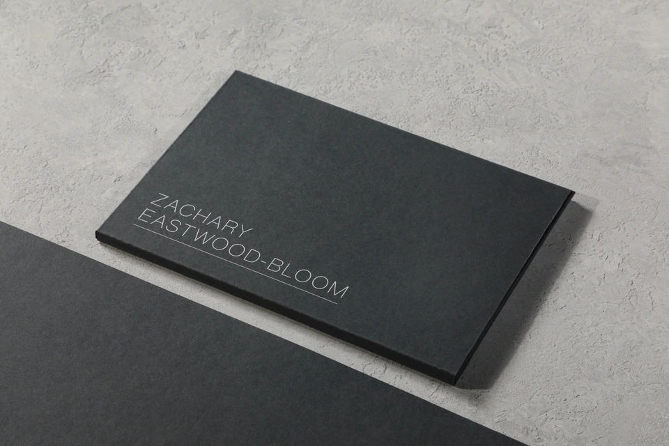 A black business card sitting on top of a table — stock style reference